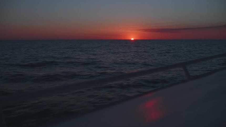 A sunset seen over the ocean from a boat