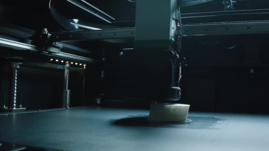 Closeup of a machine performing movements on top of an abstract white object