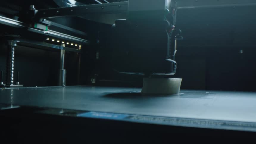 A robotic machine polishes a white object