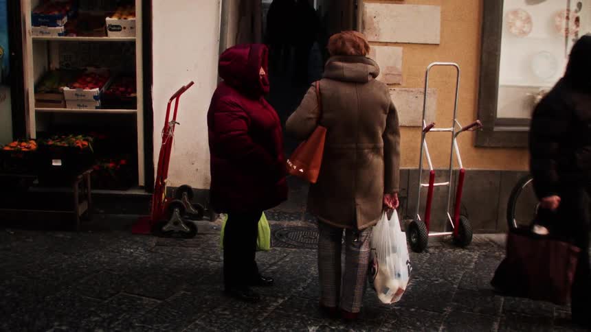 People on the sidewalk in front of an establishment