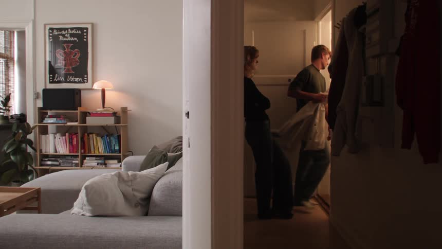 Young couple having an argument in the apartment hallway
