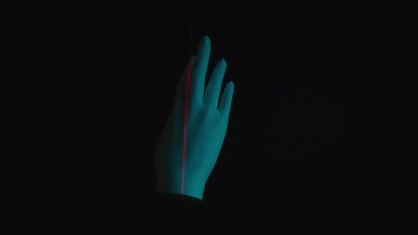 Plaster hand rotating with flashing lights in red laser light beam