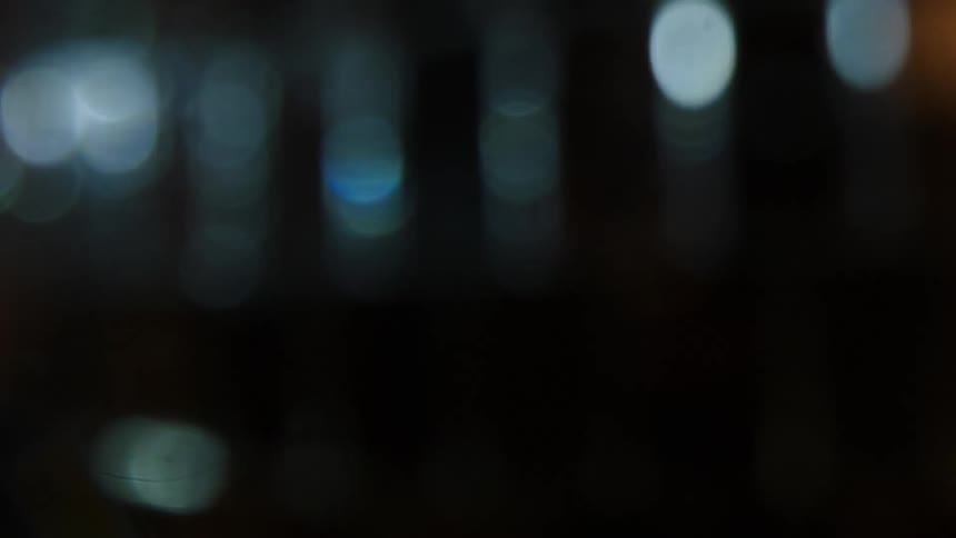 Blurred lights passing in directions in a dark environment