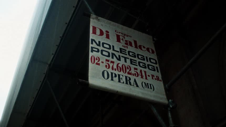 A sign in italian hangs outside a business