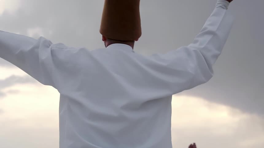 A clip of priests dancing in white garment