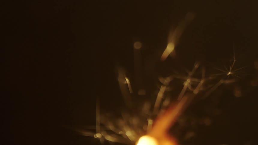 Extreme closeup on a celebratory candle burning in slow motion