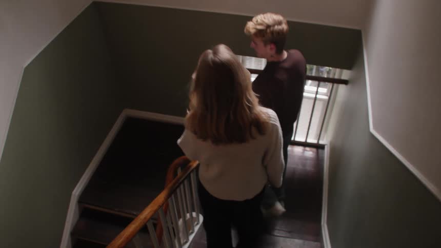 Couple walking down the stairs of a building