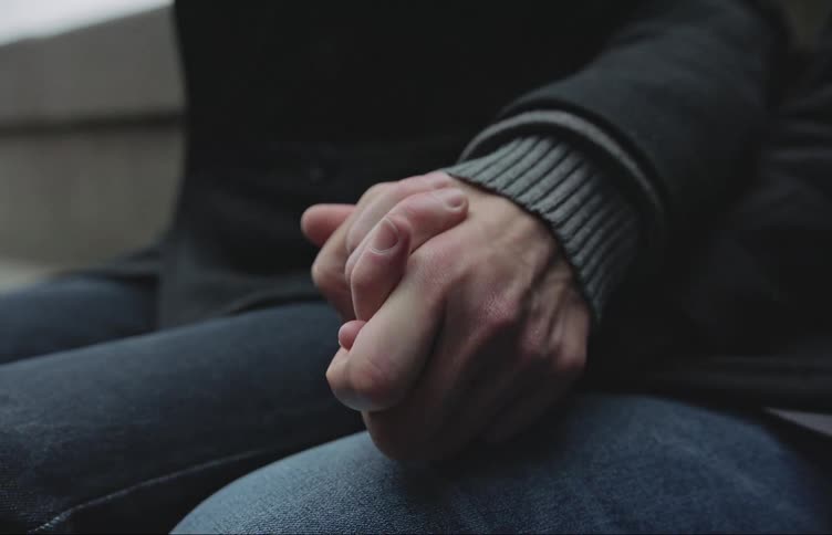 People with their hands clasped during the cold day