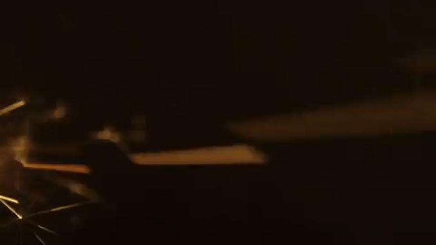 Extreme close up in candle sparks in a dark environment