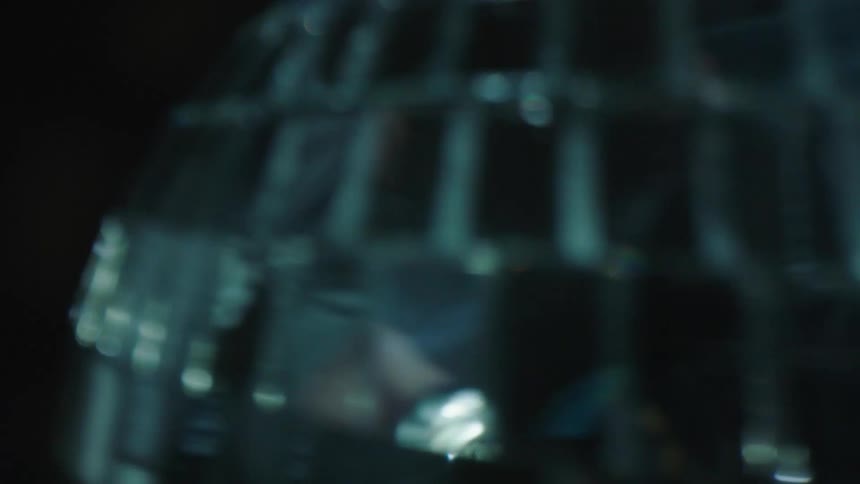 Extreme closeup on a disco ball spinning in a dark room