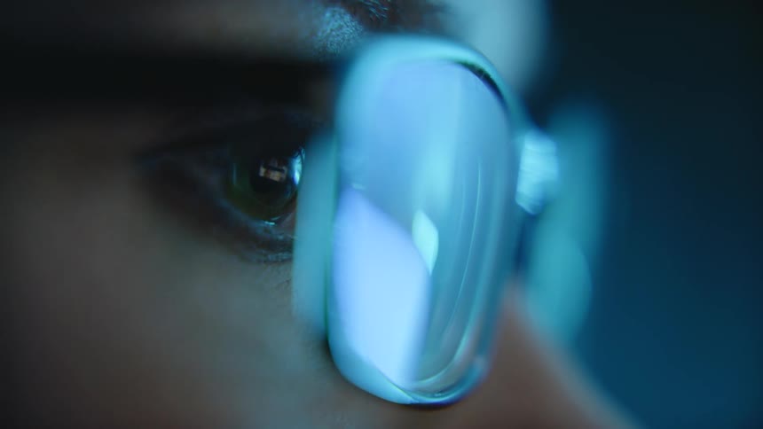 Closeup of a persons eye wearing prescription glasses