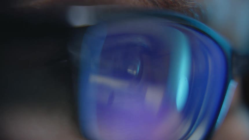 Images reflected in the lenses of a pair of glasses