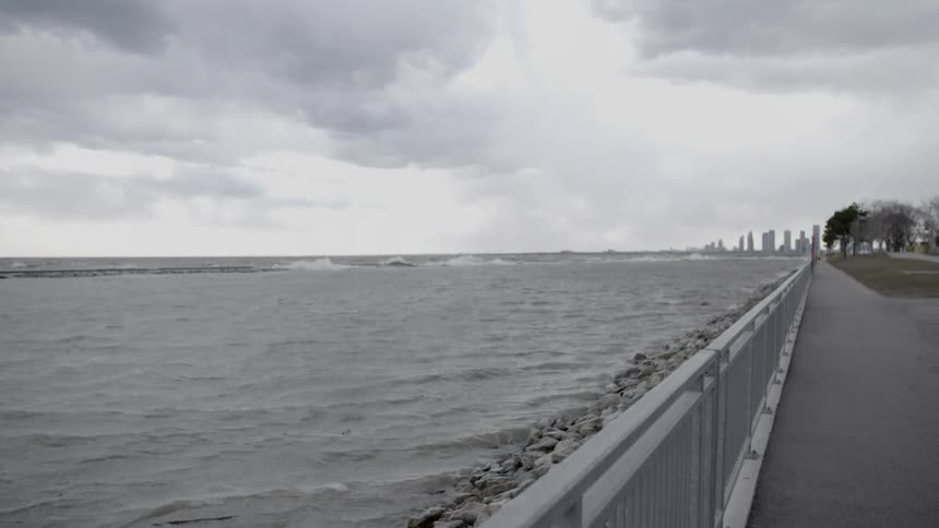 Ocean waters flowing next to a walkway