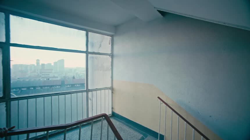 A young boy walks down stairs