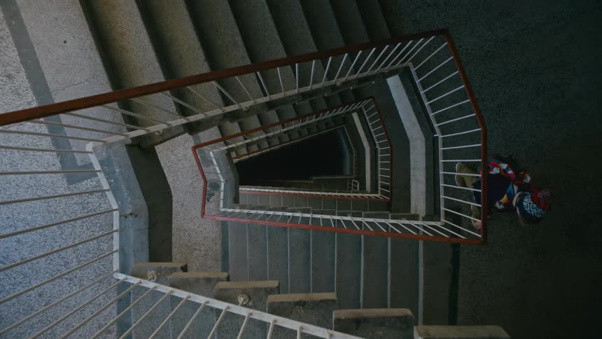 A child going down the stairs of a building
