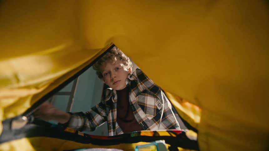 A boy is packing his bag