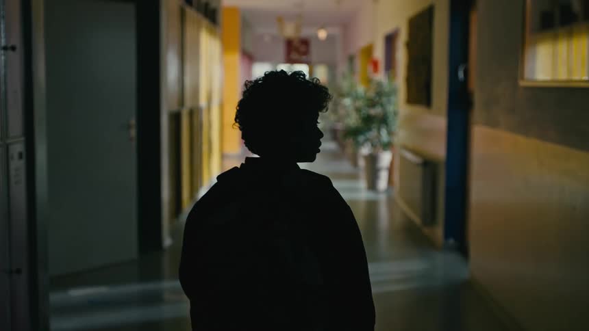 A child walking in a school hallway