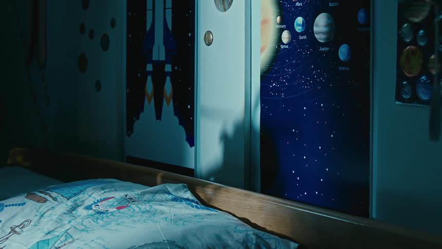 Boy playing with a toy helicopter in the bedroom