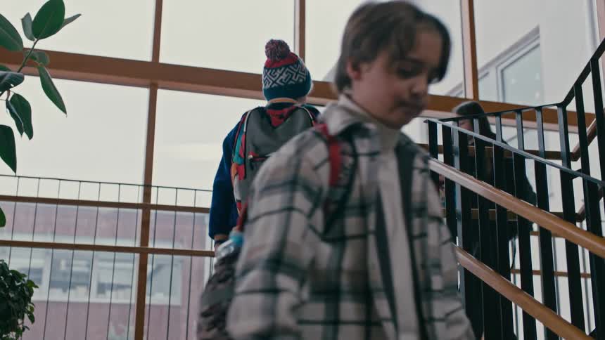 A boy and a girl collide on the staircase