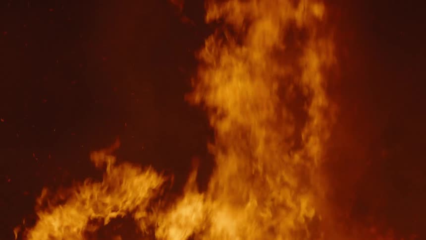 Flames of a large bonfire at night