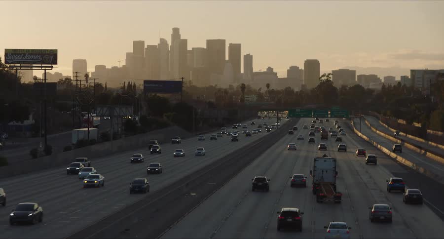Panorama of a highway with vehicle traffic and downtown Los Angeles in the background