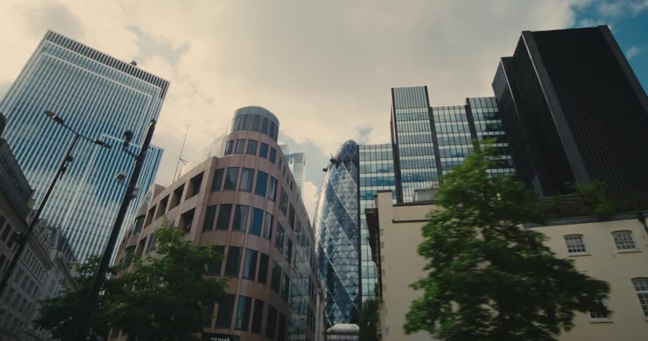 Vehicle drives down the big street with skyscrapers in the background