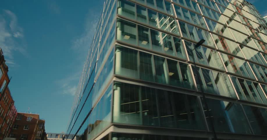 A building with glass windows sits in a city