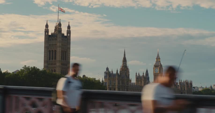Big ben and parliament are seen from a moving car on a bridge in downtown london