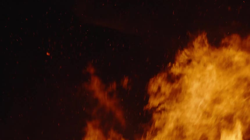 A fire is raging at night