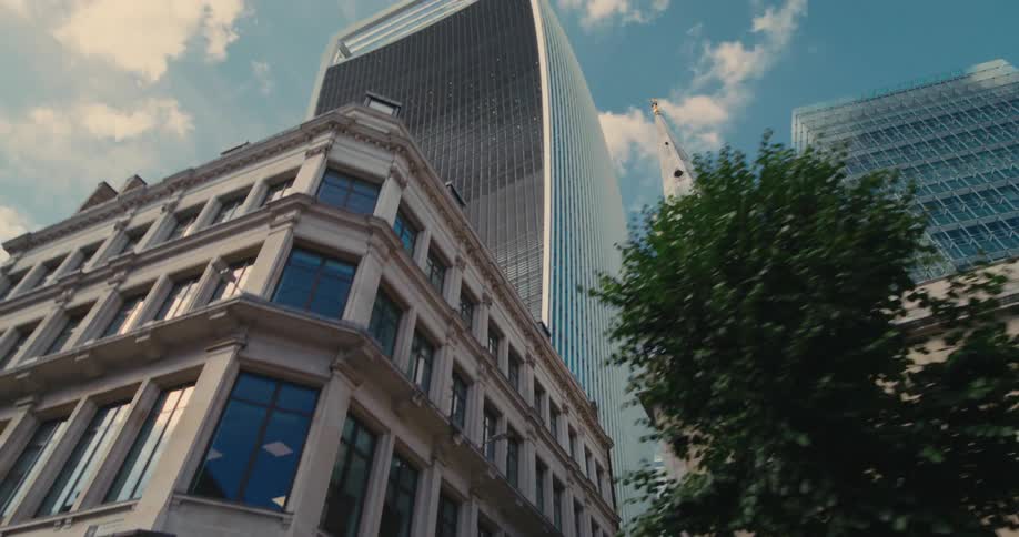 Upward view of modern skyscrapers and a church tower