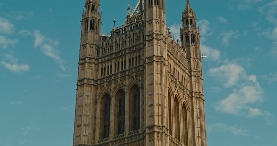The Union Jack waves over Westminster Abbey as a plane flies behind