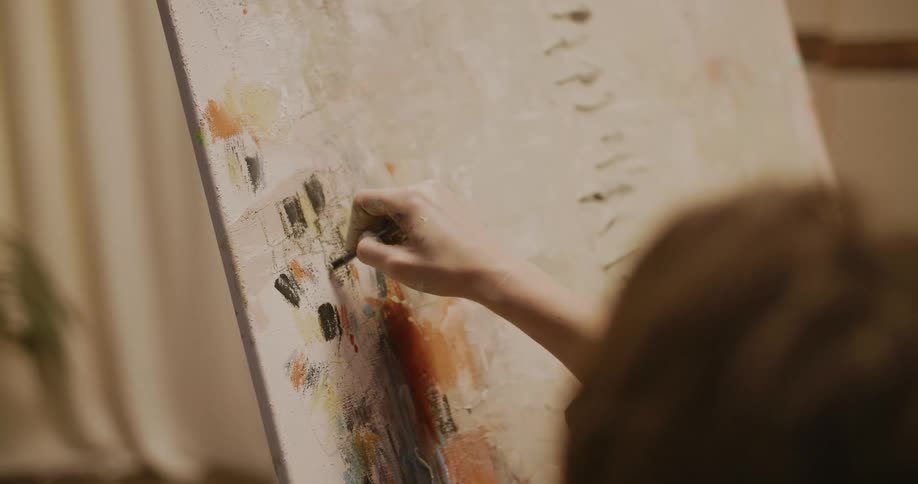 Artist draws in pastels on thin canvas