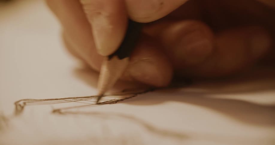 A person drawing on a sheet of paper