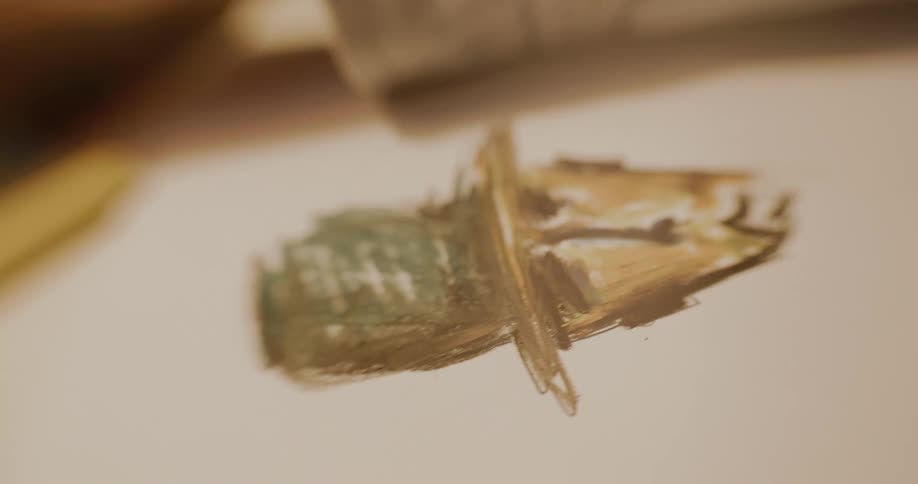 Closeup of an artists hand drawing and erasing her drawing on a blank sheet of paper