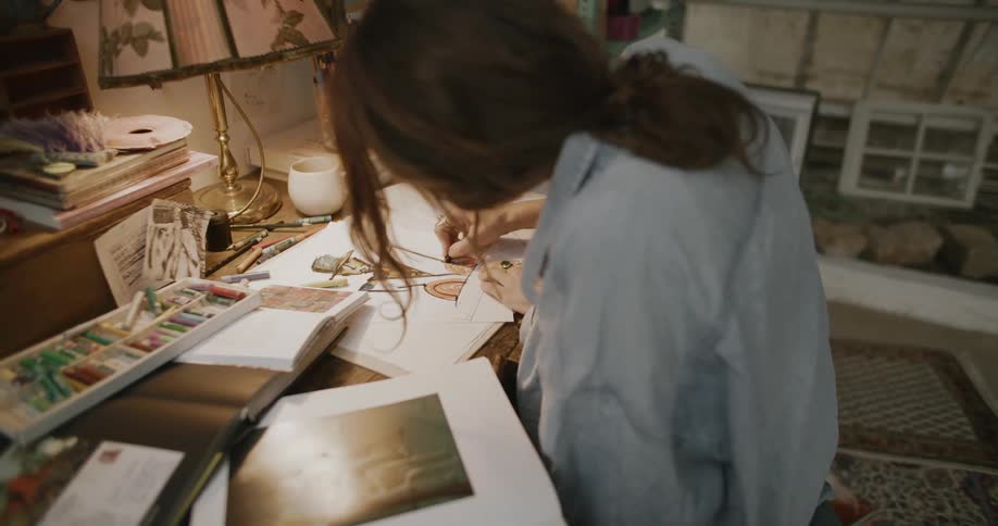 A woman is drawing on a pad