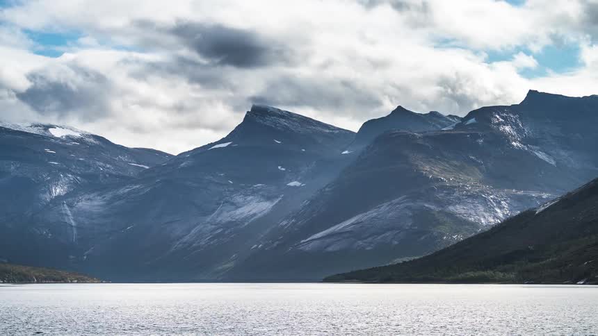 The sea between mountain ranges during a cloudy day