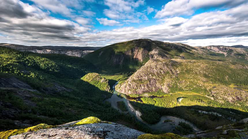 The clouds cast a shadow on the mountains