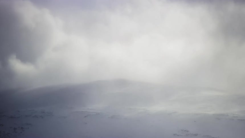 Clouds flow over the snow