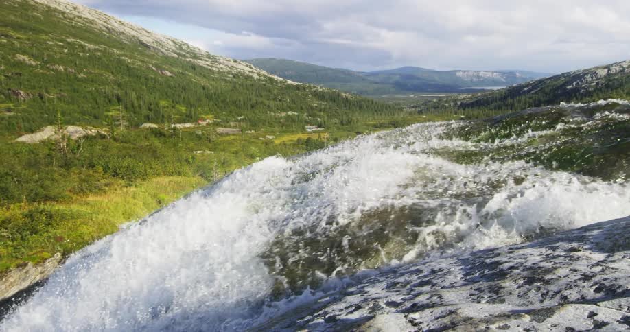 Aerial of a waterfall on a mountain during the day