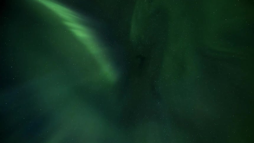 The aurora borealis with blue and green colors moving in a starry sky