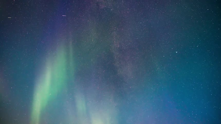 The aurora borealis lights up the starry sky