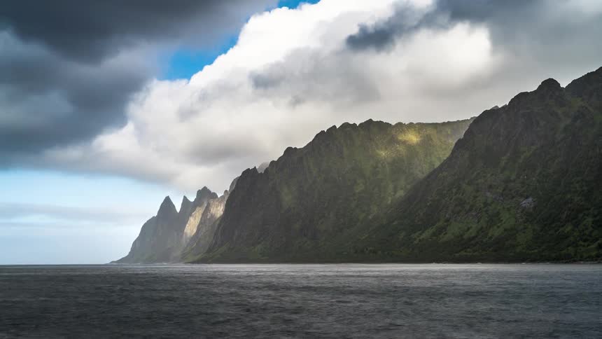 The clouds flow over the mountains