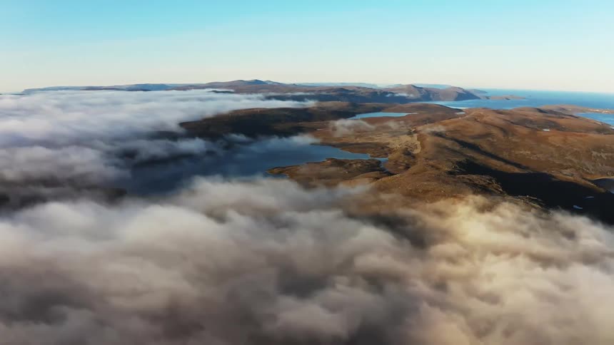 Clouds floating over a large land mass