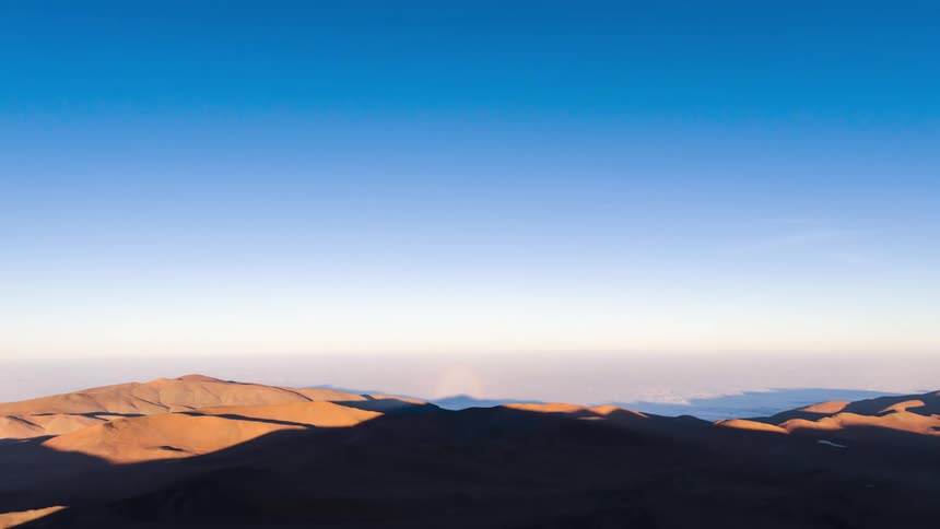 Sunlight advancing over shadow in a desert