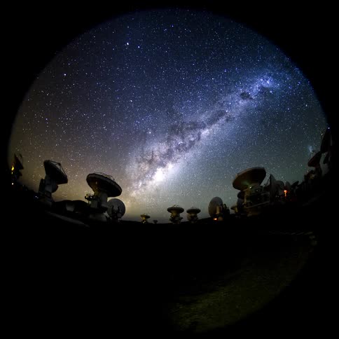 A region with several telescopes pointed at the starry sky