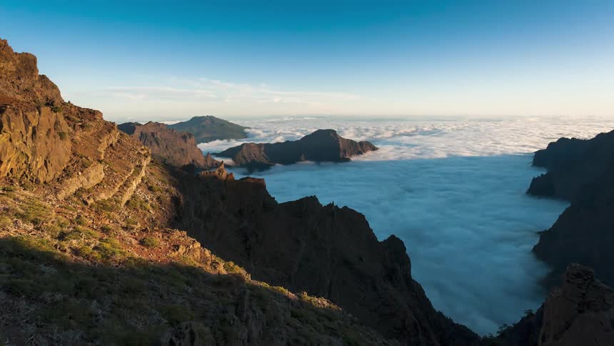Aerial of mountains covered by clouds during the day