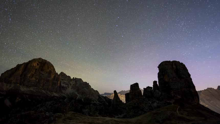 A region with many tall rock formations and the starry sky and soon after dawn the day becomes clear and the sky is blue