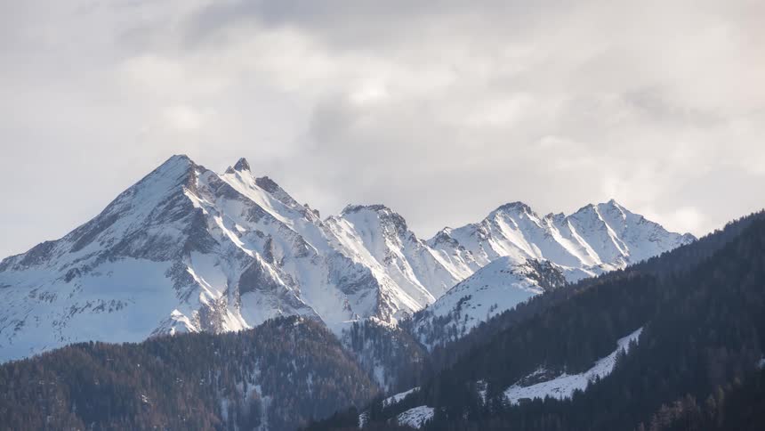 Landscape of mountains covered in snow at midday