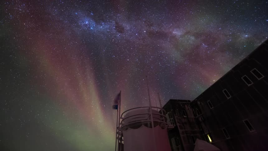 The aurora flashes over the building