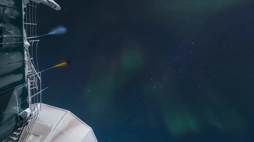 A green aurora over an observatory